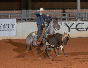 Miles Baker heeling a steer on The Darkk Side.
