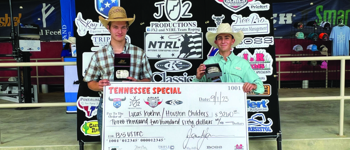 Lucas Koehn and Houston Childers stand next to each other holding a large check for $3,260.