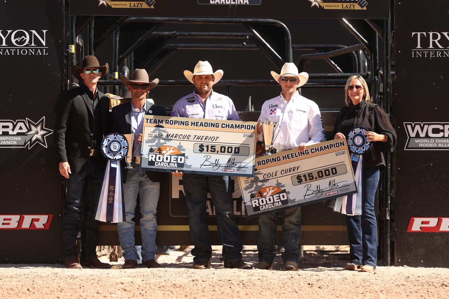 Marcus Theriot and Cole Curry pose with their checks after winning the 2023 WCRA Rodeo Carolina.