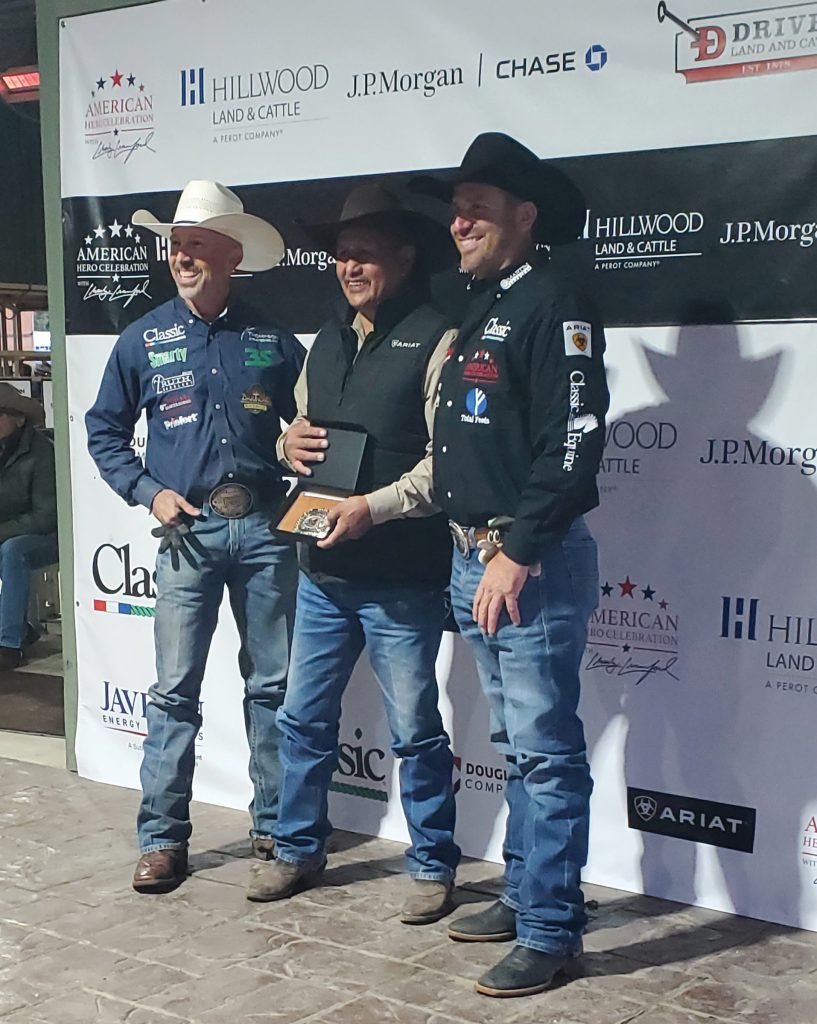 Darrell Pino accepts his Top Hand award from Trey Johnson and Charly Crawford.