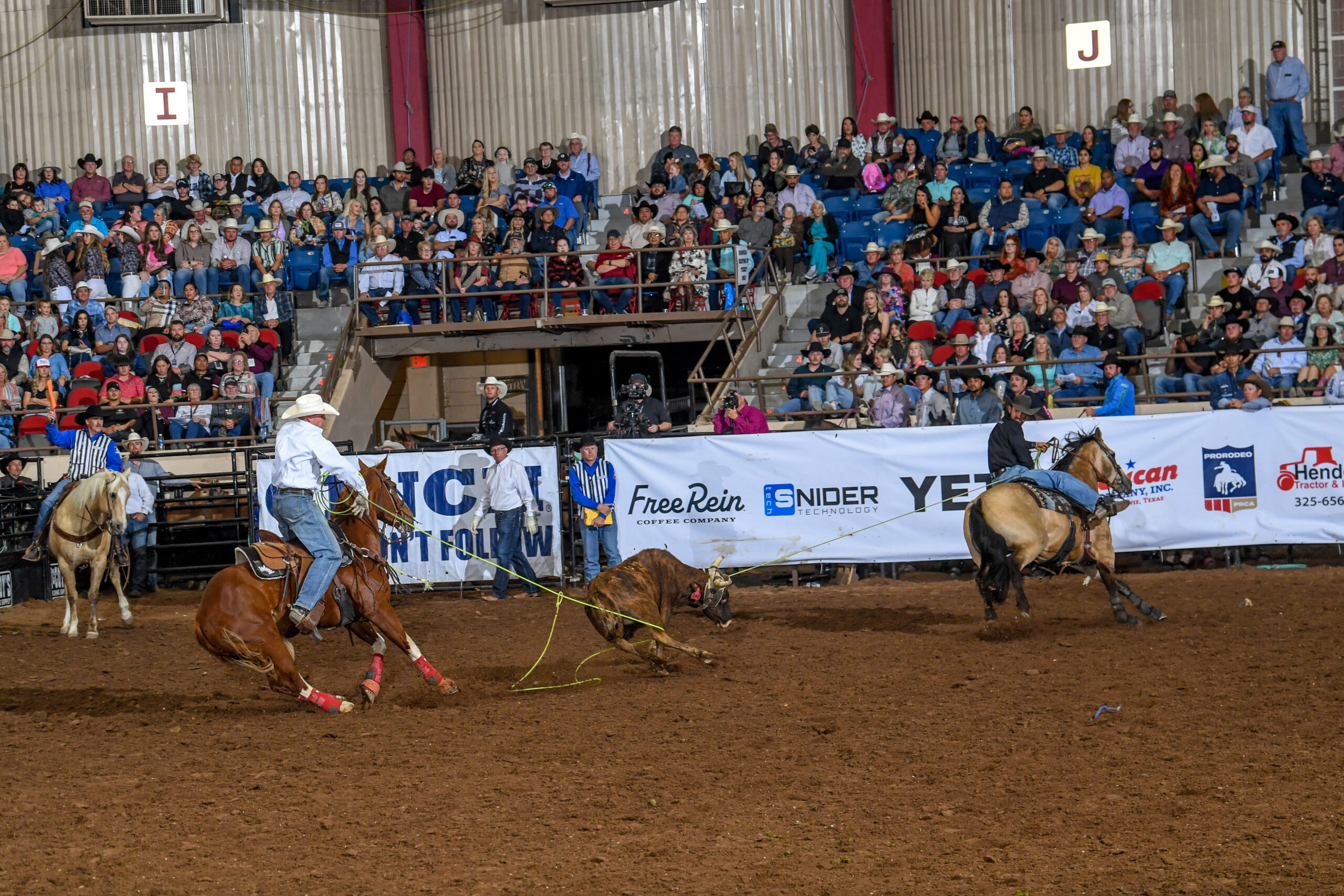 Jace Helton heeling a steer behind Shay Carroll to win the San Angelo rodeo.