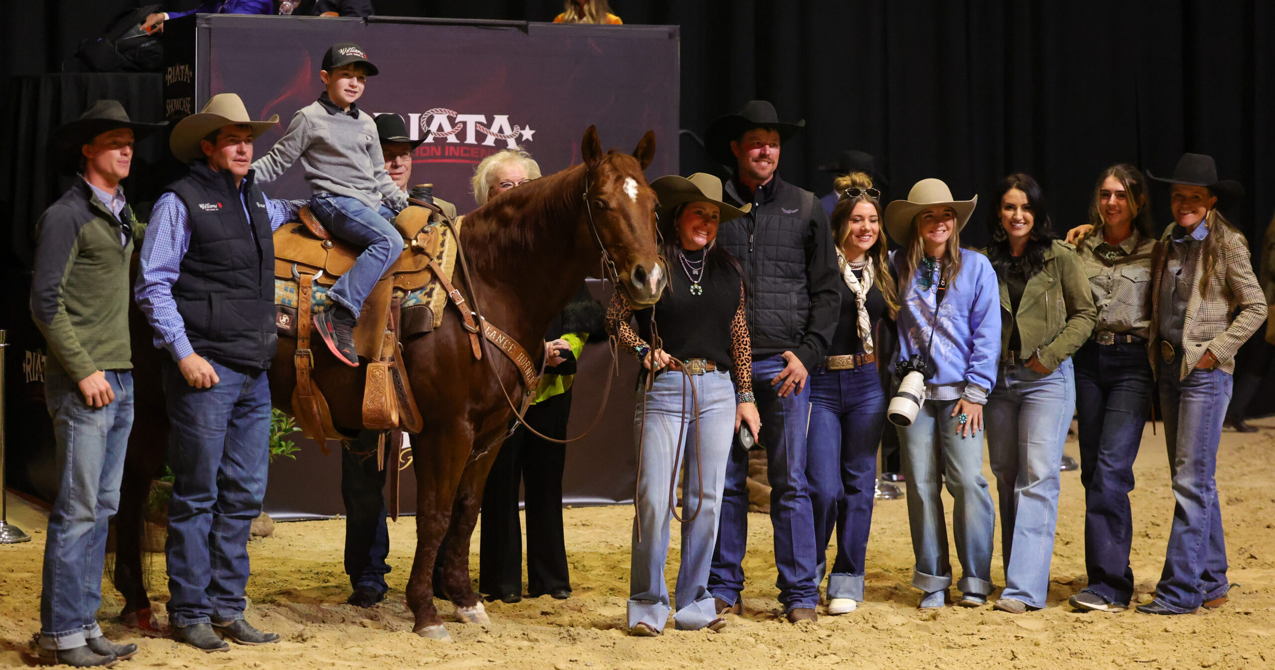 Exagereyt stands proudly with his consigners and team after bringing $170K in the Riata Stallion Showcase Horse Sale.