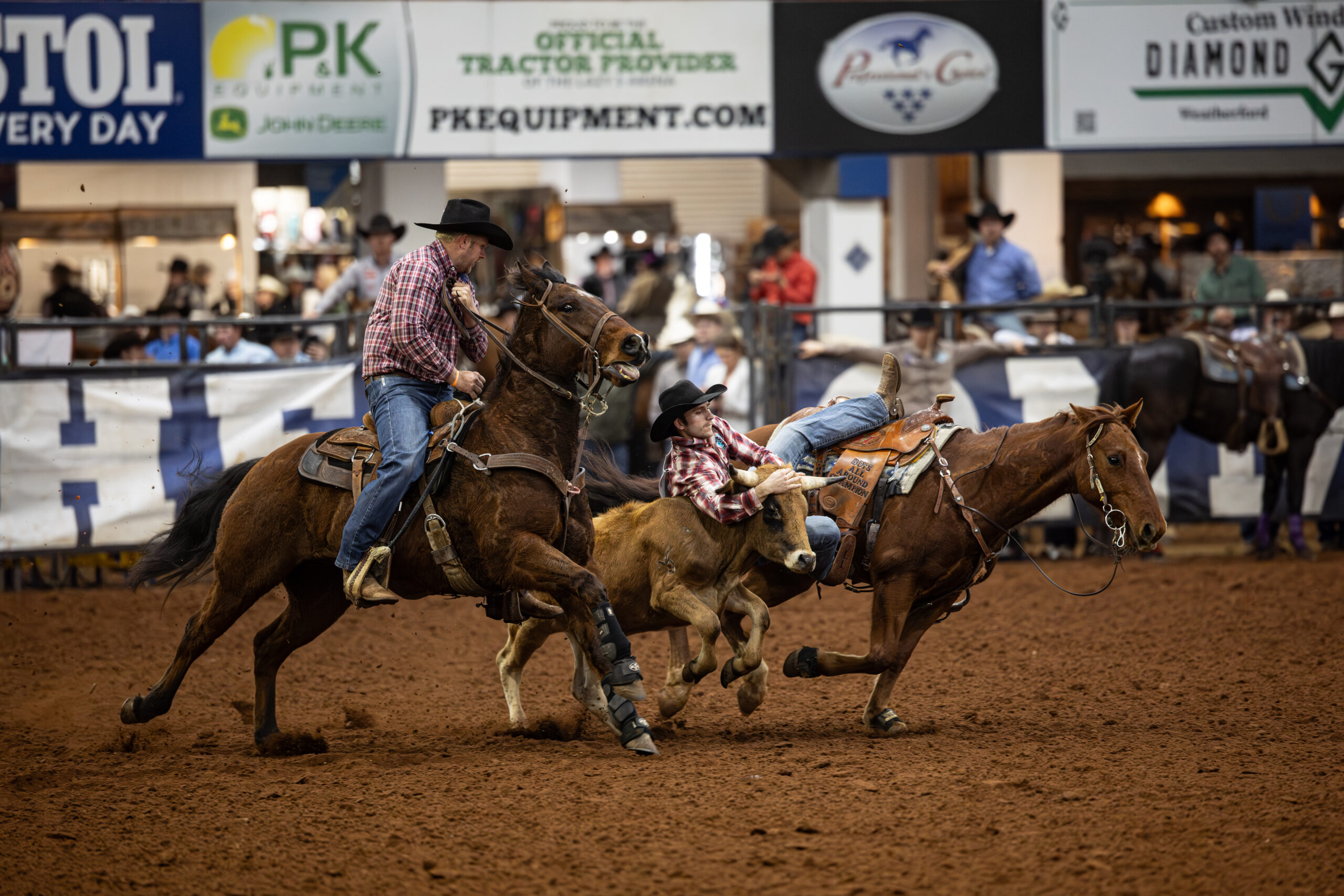Leo Loucks jumps off a horse in the steer wrestling