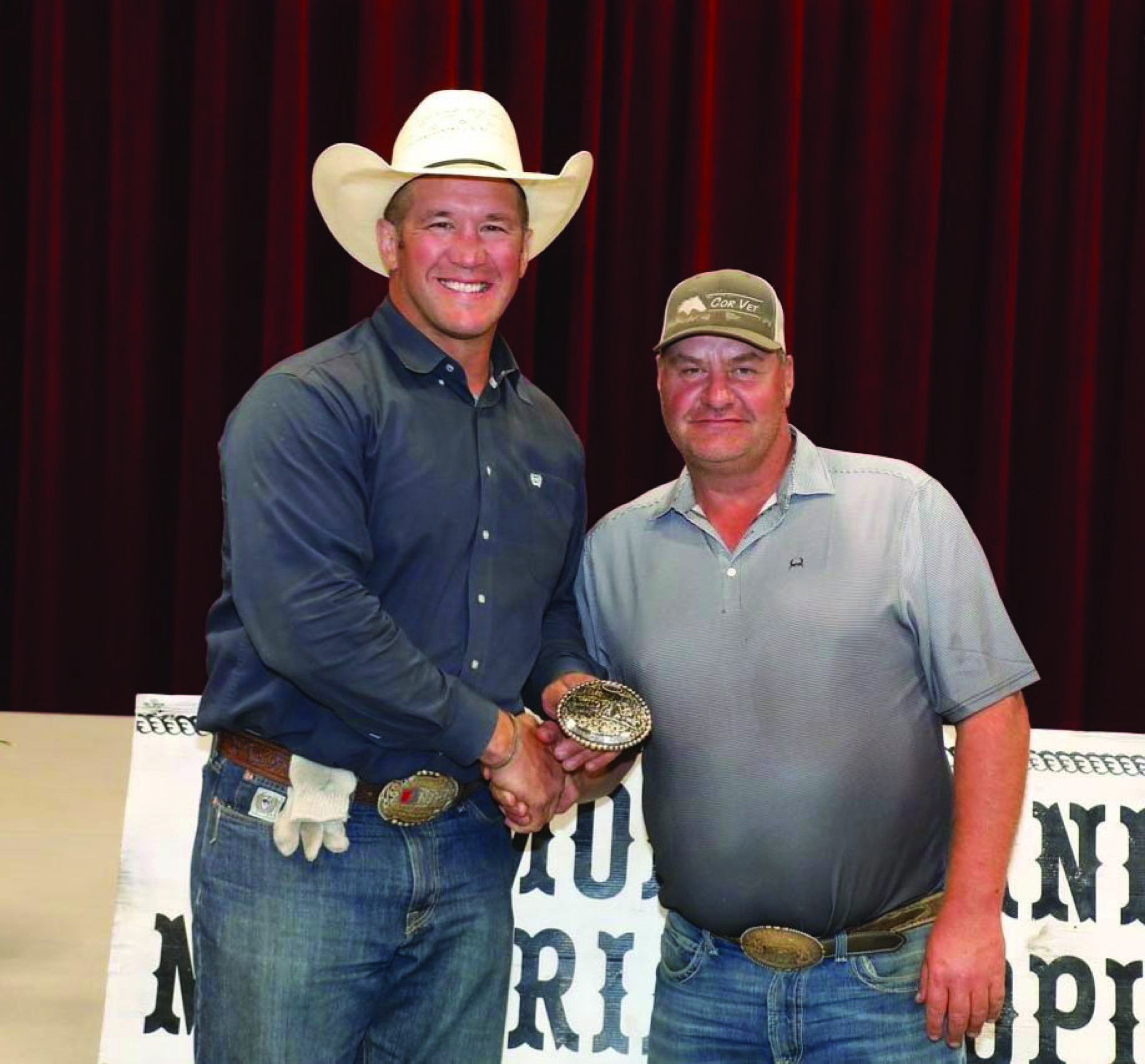 Steve MacIntyre accepts the Rickey Green memorial buckle from Kevin Schreiner