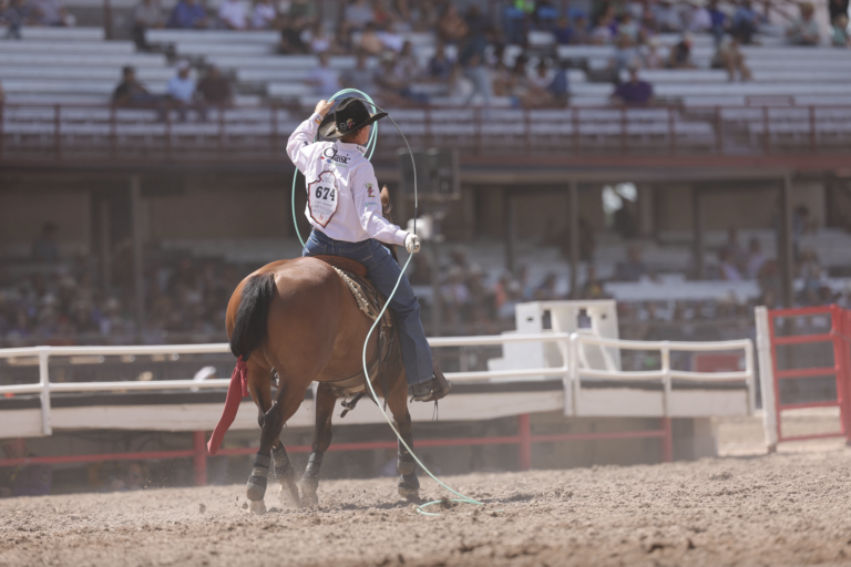 Trey Yates rides down the Cheyenne Frontier Days arena after roping