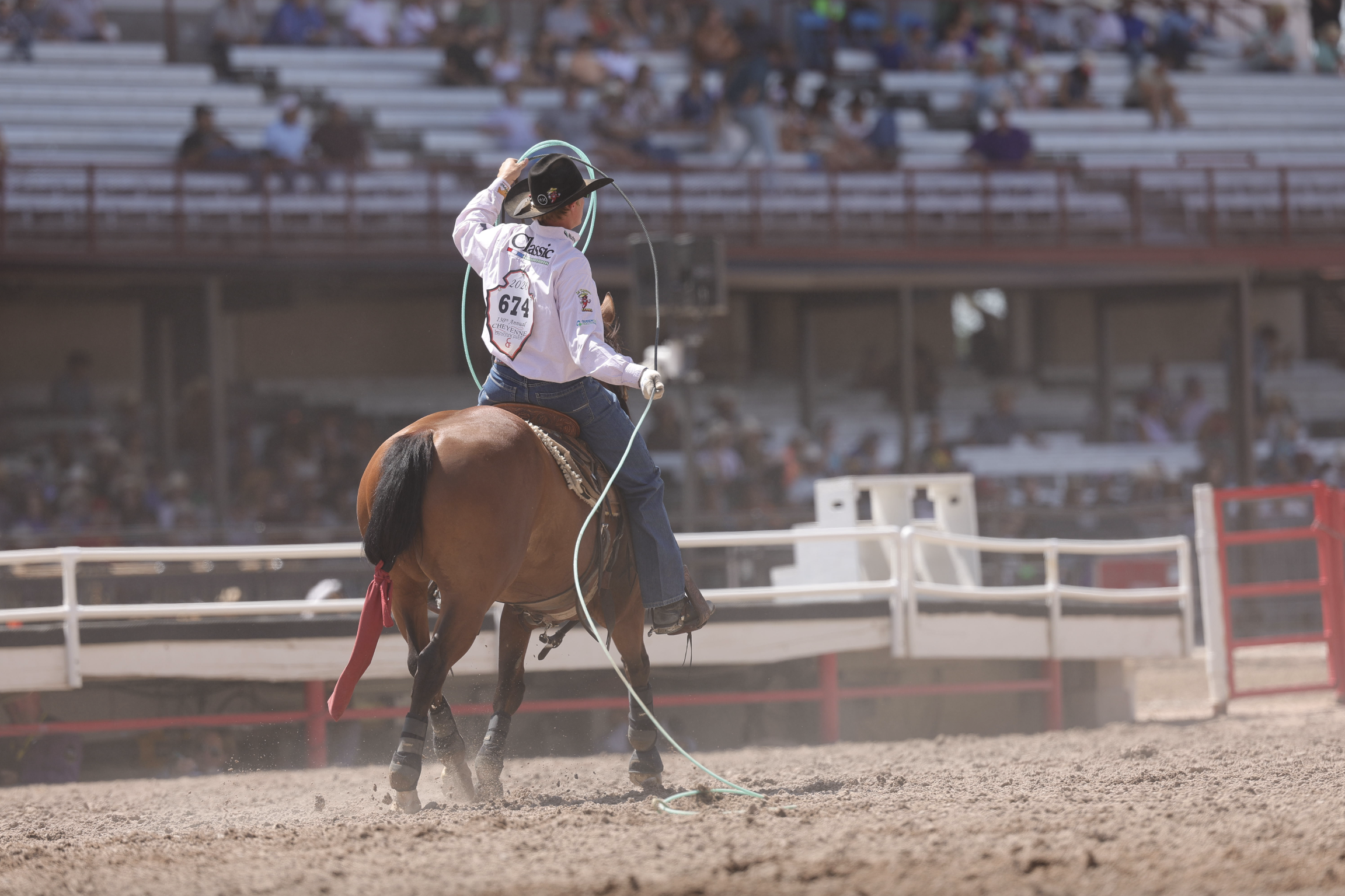 Trey Yates rides down the Cheyenne Frontier Days arena after roping