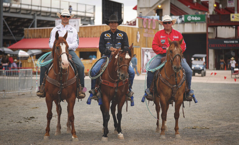 Korbin Rice, Derrick Begay and Cooper Feeman on horses, standing side by side, smiling at camera.