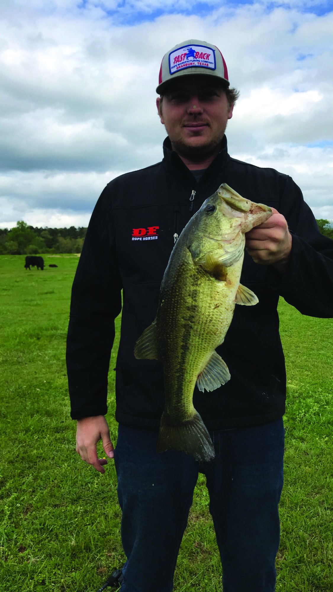 Trent Vaught holding a fish he caught while off the rodeo trail