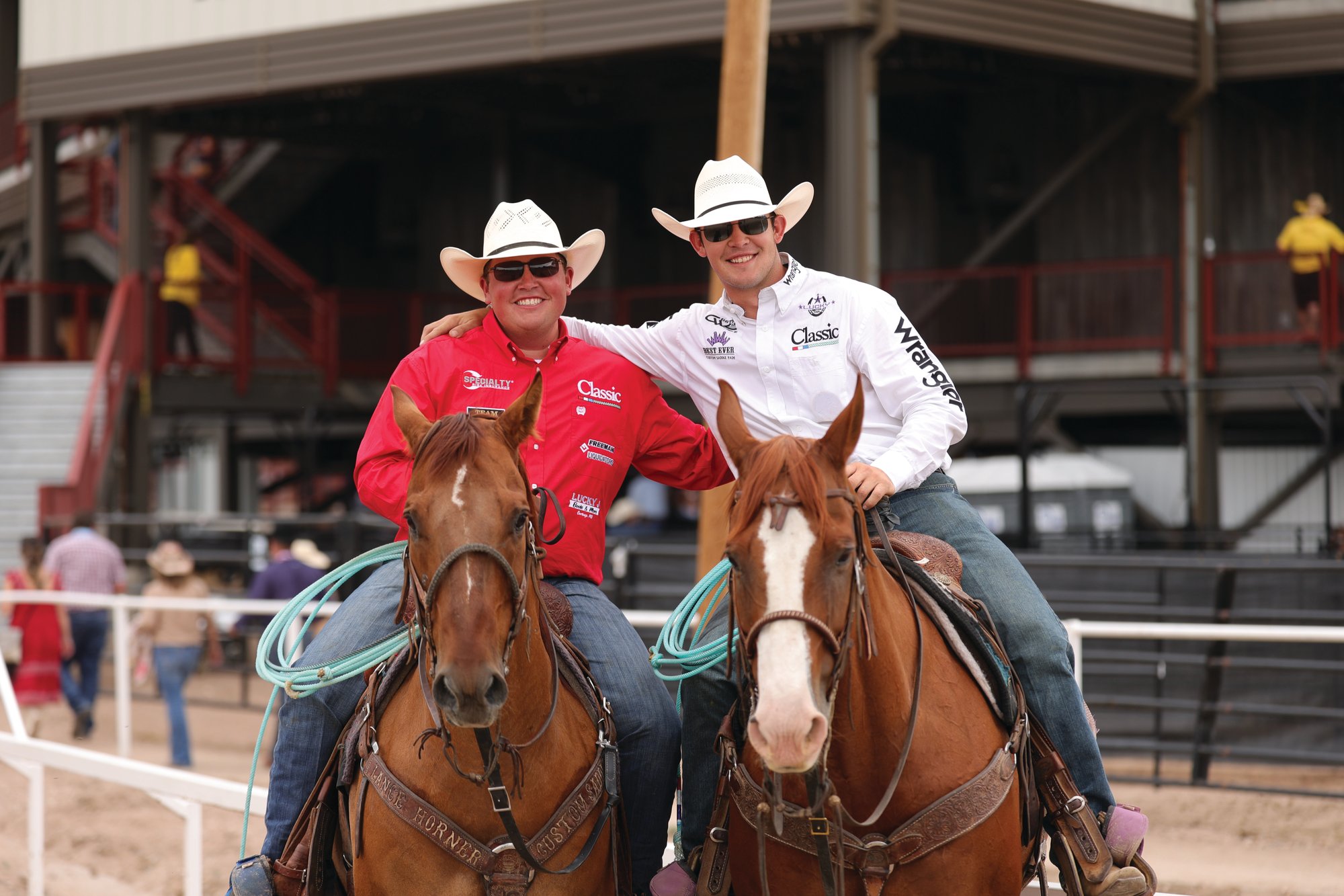Korbin Rice and Cooper Freeman on horseback together, arms around each other's shoulders