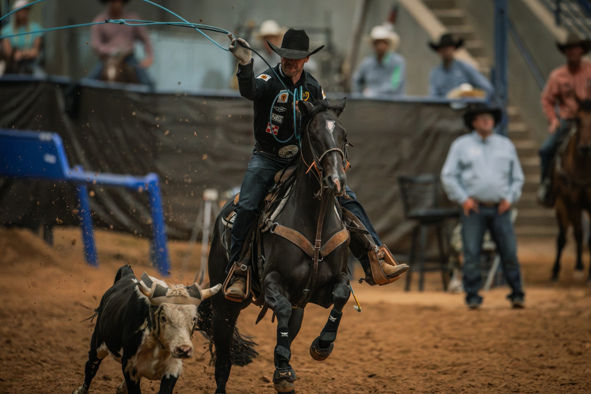 Miles Baker swings his rope on Fendiii as a steer runs ahead in the arena at the Old West World Championships in Amarillo, Texas.