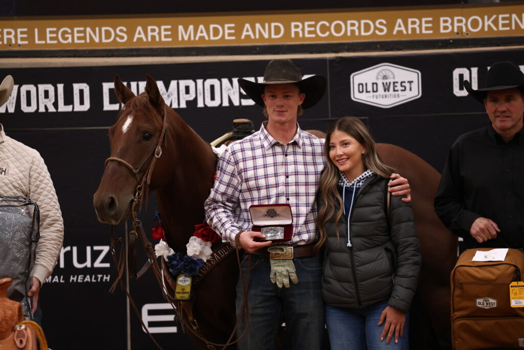 Sylais York holds a trophy buckle beside Dainty Rey Cat at the Old West World Championships in Amarillo, Texas.