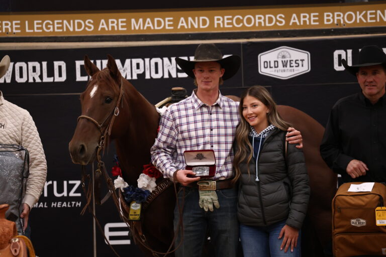 Sylais York holds a trophy buckle beside Dainty Rey Cat at the Old West World Championships in Amarillo, Texas.