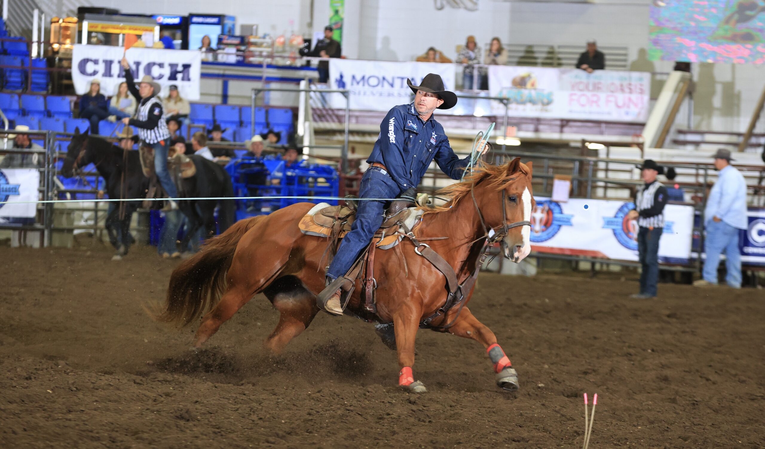 Logan Olson rides a sorrel horse while heading at the Badlands Circuit Finals in Minot, North Dakota.