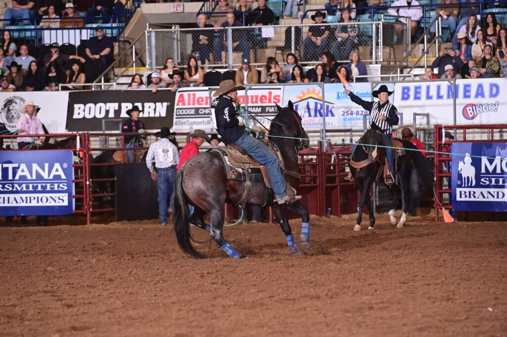 Ross Ashford rides a blue roan horse in the arena at the Texas Circuit Finals in Waco, Texas.