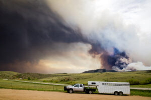 truck and trailer with smoke in the background