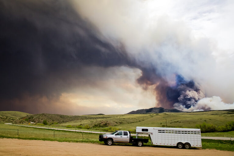 truck and trailer with smoke in the background