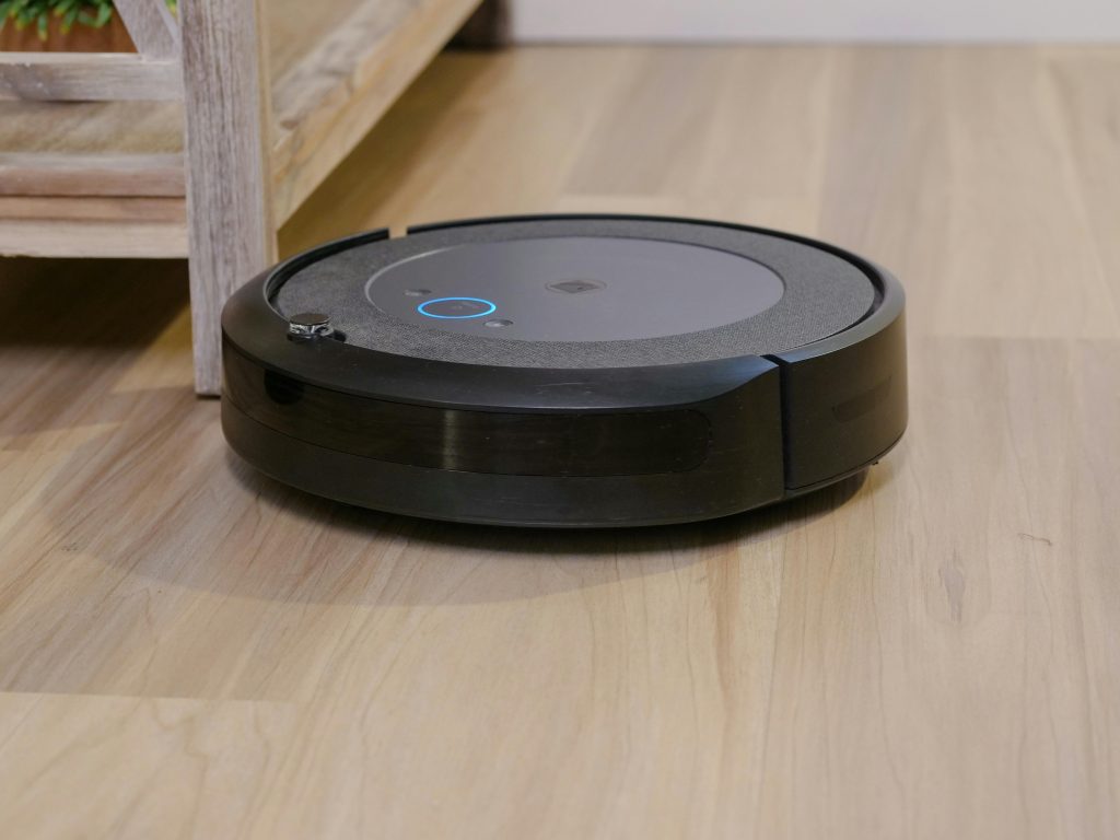 Black round device on brown wooden flooring
