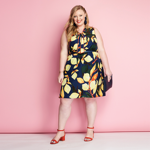 A woman wearing a Spring print dress and red heels by Dia&Co