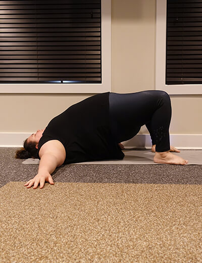 plus size woman doing yoga bridge
