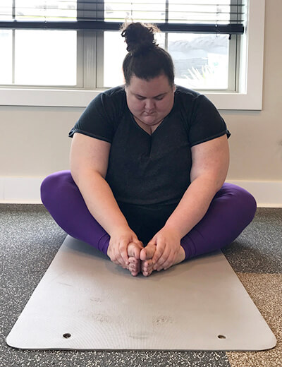 plus size woman doing yoga butterfly pose