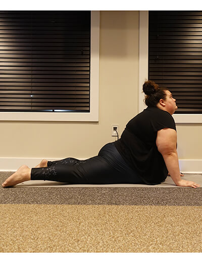 plus size woman doing yoga cobra pose