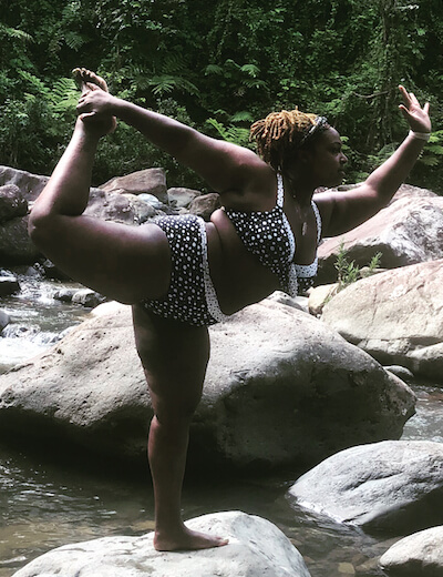 Deanna shows off a challenging yoga pose, while balanced on a rock