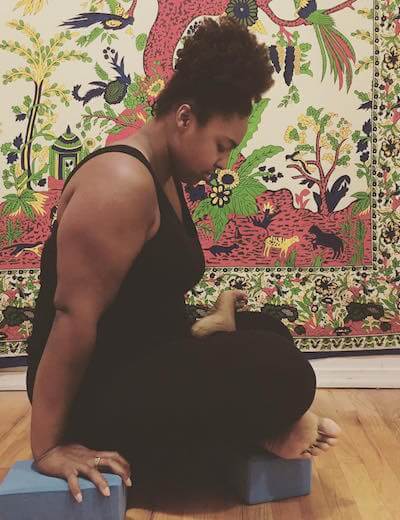 Deanna, holding a yoga pose.