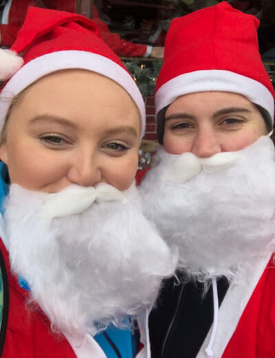 Dia Stylist Ashby and Sarah wear Santa suits in preparation of the Santa Run.
