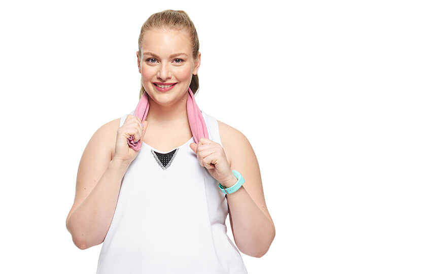Woman in workout outfit with towel around her neck.