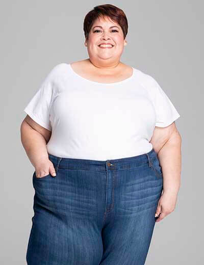 plus-size denim woman smiling in leroy jeans
