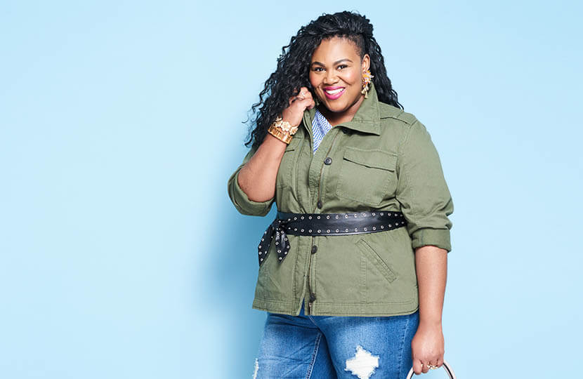 Plus size model wearing light layers for spring.