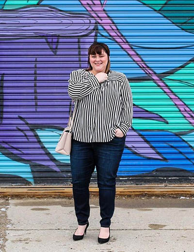 plus-size outfit photos striped shirt black jeans graffiti wall