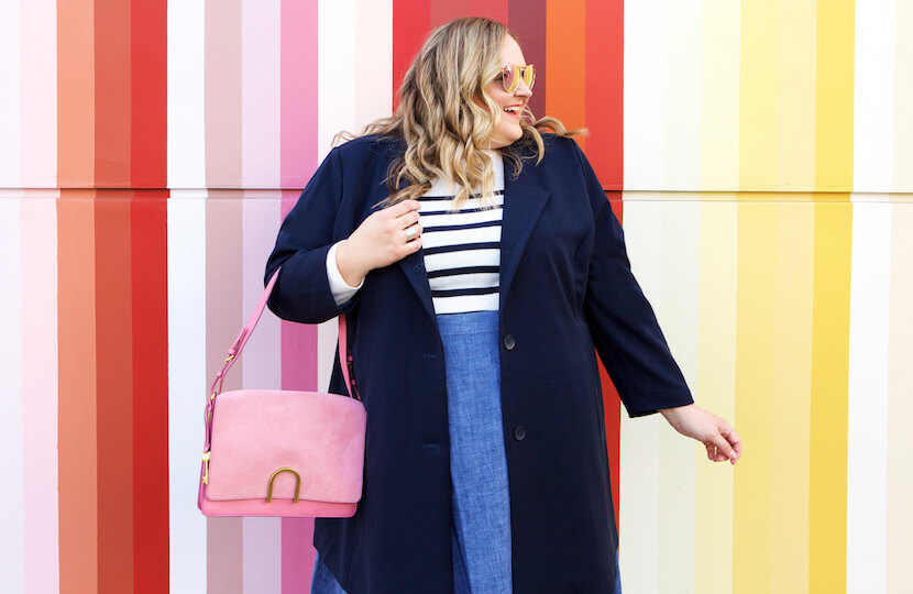 Reah Norman in navy car coat.