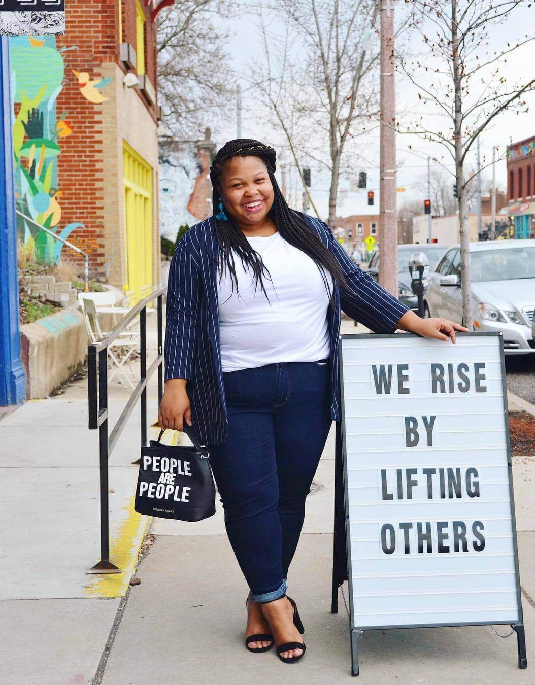 woman standing by inspirational sign