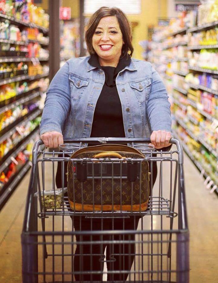april wiencek the tipsy housewife pushing shopping cart in plus size denim jacket and black outfit