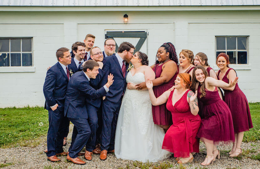plus size bride and groom with bridal party