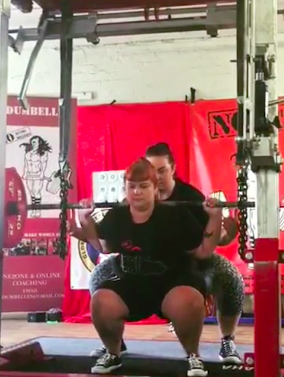 plus size women weight lifting with trainer