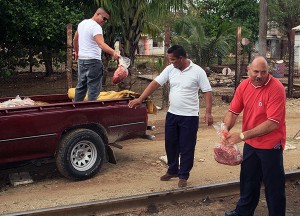 Bags of burger were unloaded from this pickup truck to a nearby restaurant using a chain of six or seven people.
