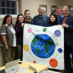 Students present climate action banner to district