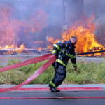 Massive blaze razes two buildings