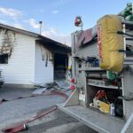 Firefighters halt garage fire spreading to home