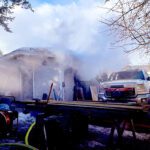 Garage and vehicle damaged in morning fire