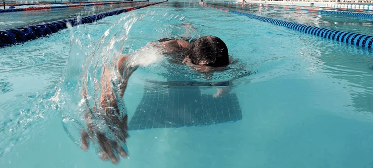 A man swimming in a pool.