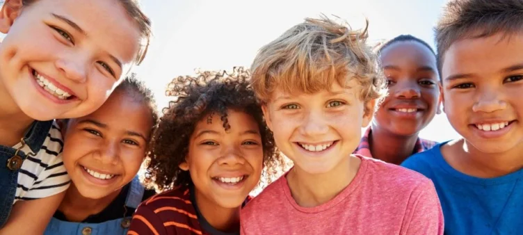 A group of kids smiling for the photo.