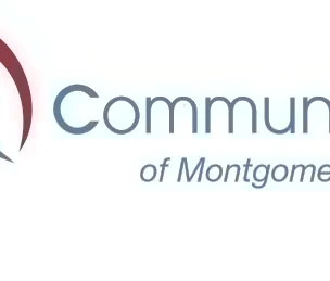 Logo for Community Reach of Montgomery County featuring a red heart outline with a blue handshake inside, next to the organization’s name in blue text.