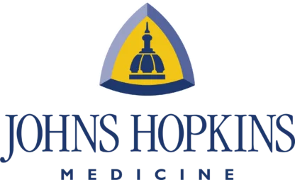 Johns Hopkins Medicine logo featuring a domed building icon inside a blue and yellow triangular shield above the text.