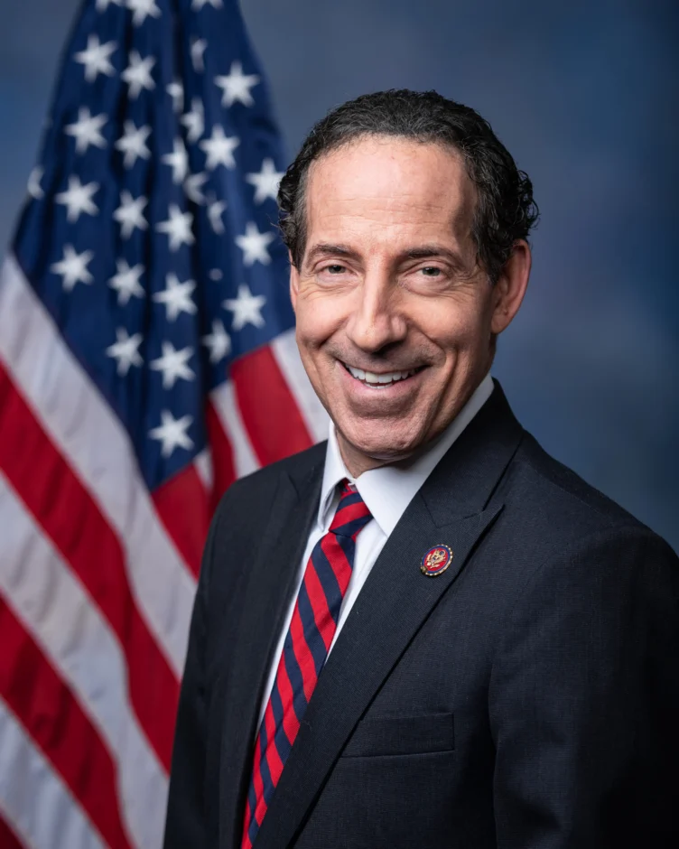 Official portrait of Congressman Jamie Raskin wearing a suit and tie in front of an American flag.