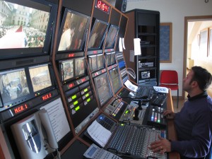 A technician works the soundboard at Tele Radio Padre Pio. | Photo by Anne Cohen.