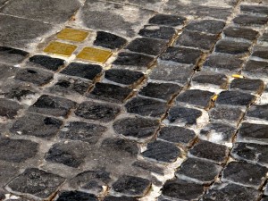 By mimicking normal cobblestones, stolpersteine become "a part of the city," says Adachiara Zevi. | Photo by Aby Sam Thomas.
