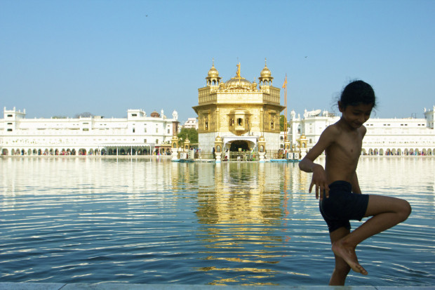 A young Sikh child steps out of the Golden Temple's holy water. Photo by Jenna Belhumeur.